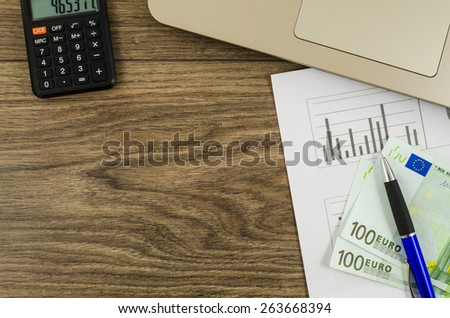 Office, business tools with euro on wooden table
