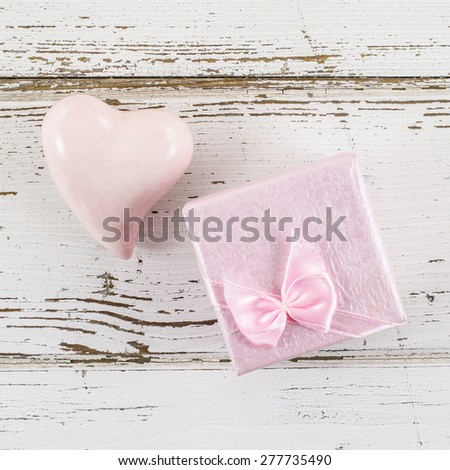 Heart and gift box on wooden table