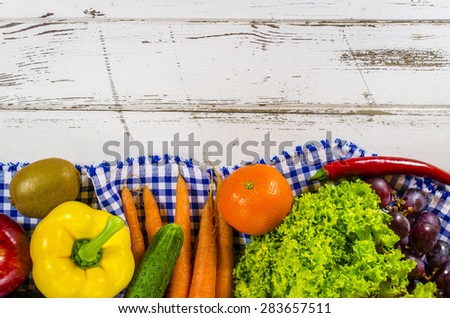 Frame of fresh fruits and vegetables on wooden table