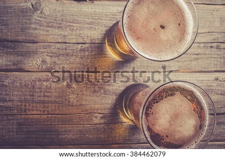Overhead shot of beer glasses on an old wooden table