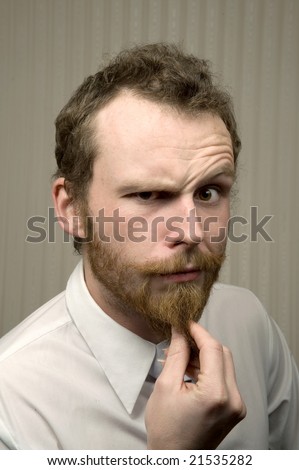 scary man in shirt and tie strokes beard