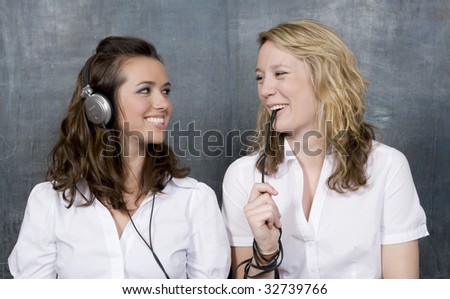 two students sit side by side, one listening while the other communicates