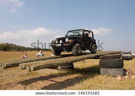 BAFOKENG - MAY 2013: Black Jeep Wrangler scaling tilt bridge obstacle at new 4x4 track opening event May 18, 2013 in Bafokeng, Rustenburg, South Africa