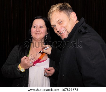 RUSTENBURG, SOUTH AFRICA - JULY 26: Singer, Songwriter and Actor, Steve Hofmeyr Performing a Song on Stage on July 26, 2013, Rustenburg, South Africa.  signature on girl\'s breast.