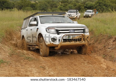 BAFOKENG - MARCH 8: White Ford Ranger XLS with Silver Canopy crossing water obstacle at Leroleng 4x4 track on March 8, 2014 in Bafokeng, Rustenburg, South Africa