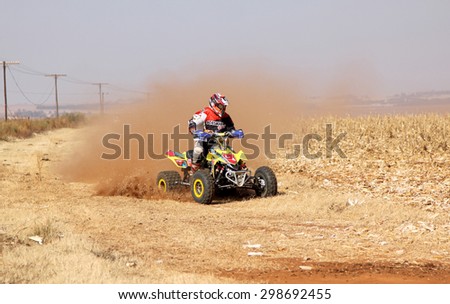 BRITS, SOUTH AFRICA - July 11:  Africa-Offroad Racing Rally,  on July 11, 2015 at Koster, North West Province, South Africa.  Quad Bike kicking up trail of dust on sand track during rally race.