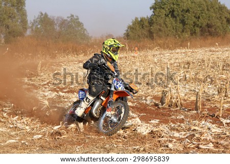 BRITS, SOUTH AFRICA - July 11:  Africa-Offroad Racing Rally,  on July 11, 2015 at Koster, North West Province, South Africa.  Motorbike kicking up trail of dust on sand track during rally race.