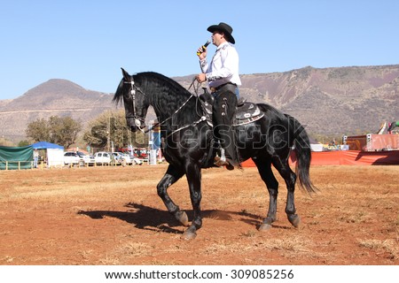 THABAZIMBI, SOUTH AFRICA - August 1:  Thabazimbi Agricultural Show, on August 1, 2014 at Thabazimbi, South Africa. Armand the singing cowboy on his black stallion.