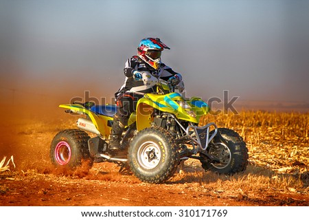 KOSTER, SOUTH AFRICA - July 11:  Africa-Offroad Racing Rally,  on July 11, 2015 at Koster, North West Province, South Africa.  hd Quad Bike kicking up trail of dust on sand track during rally race.