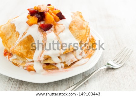 Crepes with peach fruit and cream