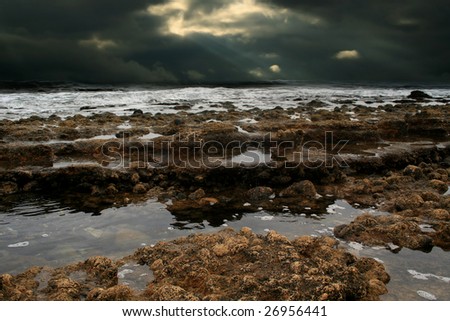 The ocean tide under dark sky