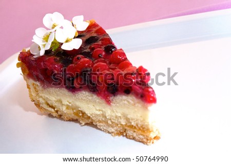 Slice of fruit cake with white decorative flowers