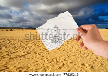 hand holds paper with sketch the fontanelle of water in the middle of the desert. The sketch present on paper is of my property