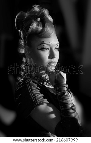 Portrait of a woman on a black background.Body Art.makeup.hairstyle.Black-and-white photo.