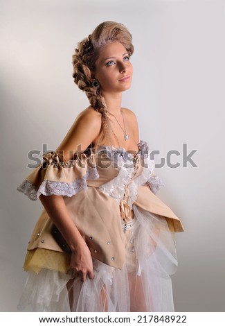 Portrait of a young girl in medieval clothes on a light background.makeup.fashion.