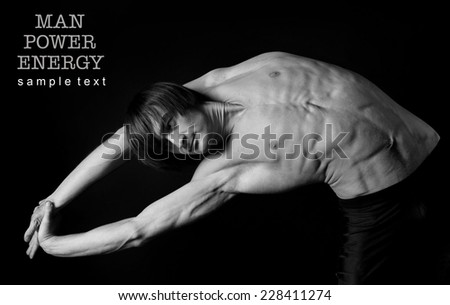 Athlete.Power.Energy.Gym.Men's sports figure on a black background.Exercise.Black-and-white image.