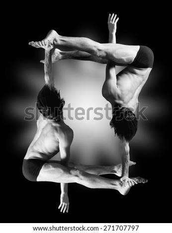 Figures gymnasts on a black background.Athletes.Handstand.Black and white image