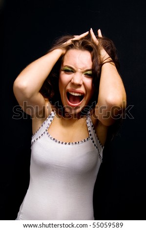 woman in hysterics on a black background.family problems.fury. - stock photo