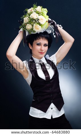 young woman with a nosegay above a head.model on a dark background.fashion and beauty