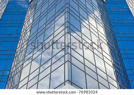 architecture.surface of glass building with the reflection of clouds
