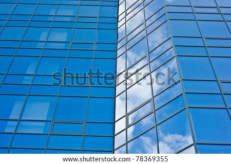 architecture.surface of glass building with the reflection of clouds