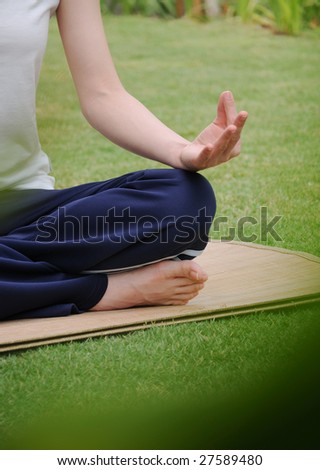 woman having yoga in the green garden