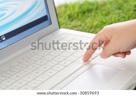children hand on laptop, image on the screen from my portfolio