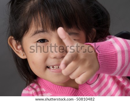 girl pointing towards the camera, focus are on the face