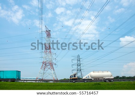 electricity pylon with cables across the road