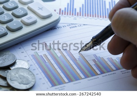 Financial data analyzing , shot with very shallow depth of field , blue tone