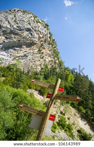 A wooden post with direction signs for the GR11.