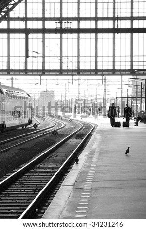 Two business man wait for they´r train to arrive.
