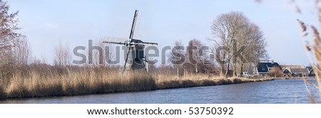 Typical Dutch landscape with windmill and a canal.