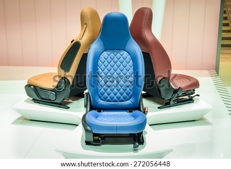 Three car tuning fine leather seats on display. Blue, beige and marsala color variations.