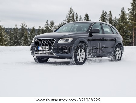 IVALO, FINLAND - February 15, 2015: Winter tire test is held at the proving ground. Test-driver performs acceleration on snow test to determine the tire which provides the best grip on snow.