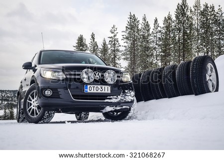 IVALO, FINLAND - February 15, 2015: Winter tire test is held at the proving ground. Test car and a set of SUV winter tires are on display. There were tests on snow and ice performed .
