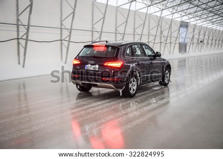 IVALO, FINLAND - February 15, 2015: Winter tire test is held at the proving ground. Test-driver performs ice braking test to determine the tire which provides the best grip on ice.