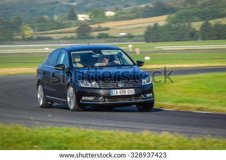 LADOUX, FRANCE - SEPTEMBER 16, 2014: Tire test is held at the proving ground. Professional test-driver performs a dry handling test to determine the tire which provides the best grip with dry road.