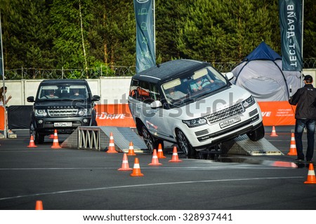MINSK, BELARUS - JUNE 20, 2015: Test-drive event for 2015 model year Land Rover and Range Rover is held in Minsk, Belarus on June 20, 2015. British SUV overcome obstacles created with terrapods.