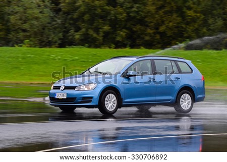 NOKIA, FINLAND - September 15, 2015: Tire test is held at the proving ground. Professional test-driver performs a wet handling test to determine the tire which provides the best grip with wet road.