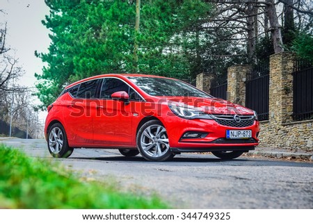 BUDAPEST, HUNGARY - NOVEMBER 27, 2015: 2016 model year Opel Astra (generation K) is on display. Red hatchback Opel Astra is equipped with headlights that consist of 16 individual matrix LED.