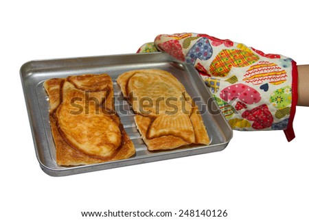 Fish Croissant  in cake tin with oven glove