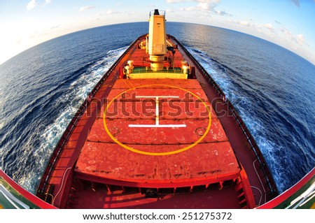 Cargo ship bulk carrier crossing ocean fish eye view half circle on top from monkey island.