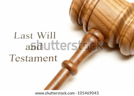 A gavel on top of will papers with the focus on the writing.