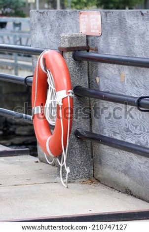 A lifesaver mounted near a danger zone of a river.