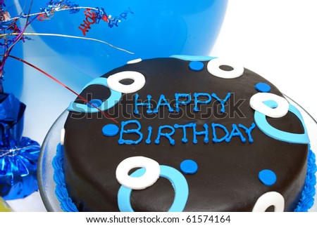 A blue decorated cake with happy birthday writing.