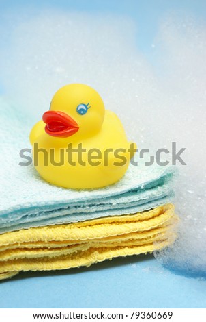 A rubber ducky and other bathing items come together to conceptualize a juveniles bath time.