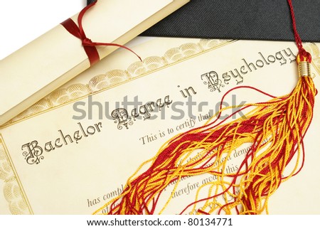 A diploma and grad hat represent a high achieving student in the field of psychology.
