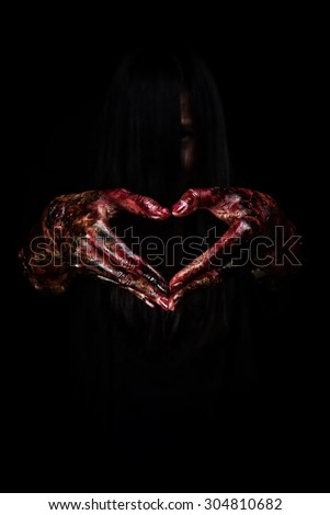 Halloween theme:Bloody hands in heart , black background, zombie, demon, killer, maniac with clipping path.