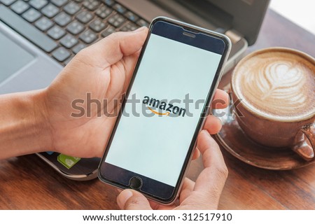 CHIANGMAI,THAILAND-SEPTEMBER 2,2015:man holding Amazon logo on Iphone6plus screen.Amazon.com, Inc. is an American international electronic commerce company.